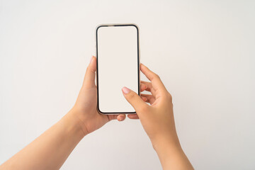 Closeup shot of a woman typing on mobile phone isolated on white background.. Girl's hand holding a...