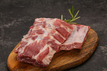 Raw pork ribs served rosemary