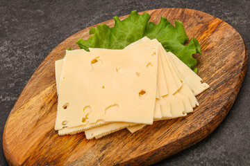 Sliced yellow cheese over board