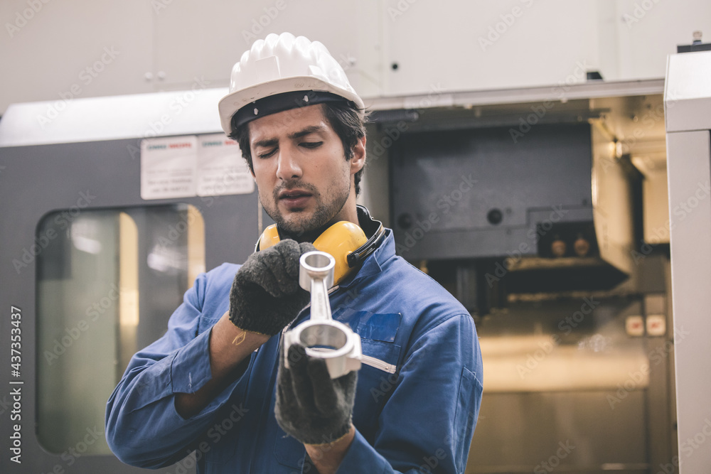 Poster workers inspecting workpieces from cnc machines