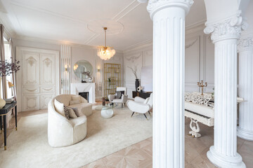 rich luxurious interior of a cozy room with modern stylish furniture nd grand piano, decorated with baroque columns and stucco on the walls