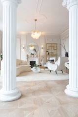 rich luxurious interior of a cozy room with modern stylish furniture nd grand piano, decorated with baroque columns and stucco on the walls