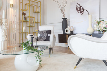 rich luxurious interior of a cozy room with modern stylish furniture nd grand piano, decorated with baroque columns and stucco on the walls