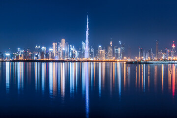 Panoramic view of the Burj Khalifa and other skyscrapers in the financial center of Dubai in the UAE with reflections in the waters of the Creek Channel