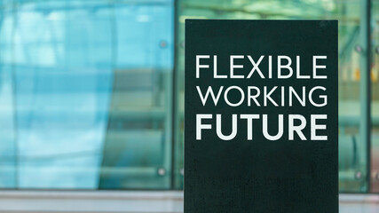 Flexible Working Future on a sign outside a modern glass office building 