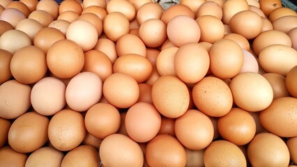 pile of domestic chicken eggs in a traditional Indonesian market. The color of the shell is dark brown with a relatively rough shell texture with a larger size. Staple food source of protein