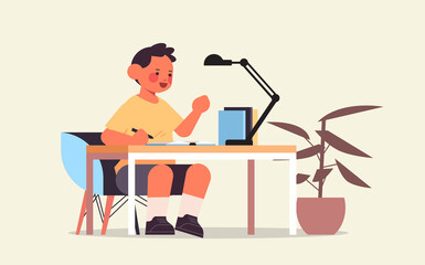 little boy studying and doing school homework education childhood concept full length