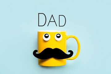 Happy Father's Day.Yellow mug with mustache and funny eyes looking up with the text Dad - obrazy, fototapety, plakaty