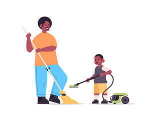 Obraz premium father and son having fun while cleaning living room parenting fatherhood friendly family concept