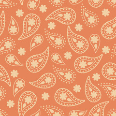 paisley silhouettes on a peach background. seamless pattern