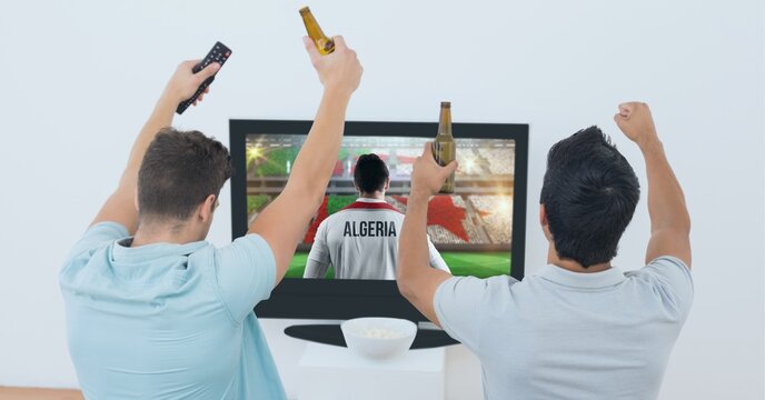 Compostion of two male friends watching football match on tv on white background