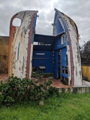 Public toilet with old boats on the Azores
