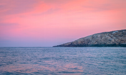 Fototapeta premium Amazing sunset polar landscape with mountain range on the horizon. Arctic ocean panoramic view.