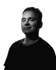Black white contrasting portrait of smiling guy on a white background