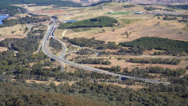 Daytime Traffic At Busy Highway In Canberra, Australia. View From Telstra Tower Observation Deck. high angle