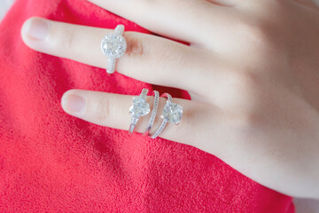 diamond rings on woman finger.love and an elegant wedding white gold ring concept
