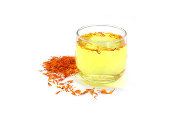 A glass of safflower tea and a pile of Dried Safflower petals herb Tea. isolated on a white background - obrazy, fototapety, plakaty