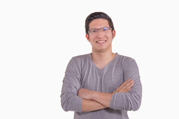Fototapeta premium Portrait of happy asia business man standing with crossed arms in grey shirt