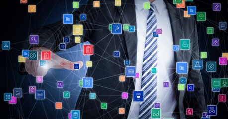 Composition of network of connections with icons over businessman touching interactive screen