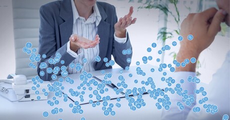 Composition of network of connections with icons over business people talking in office