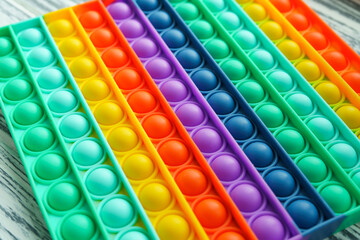 Trendy popular silicone colorful anti stress pop it toy . Close up. Someone push sensory popit. Trendy hype theme from tik tok