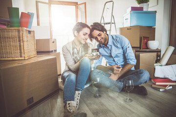 Young couple moving in into new apartment