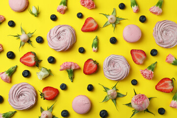 Concept of tasty macaroons and marshmallows on yellow background