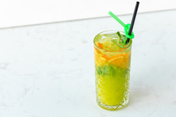 Citrus lemonade on white wooden background close up