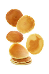 Tasty falling pancakes isolated on white background