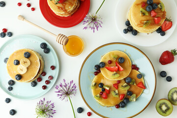 Concept of delicious dessert with pancakes on white background