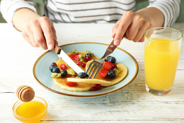 Concept of delicious dessert with pancakes on white wooden table