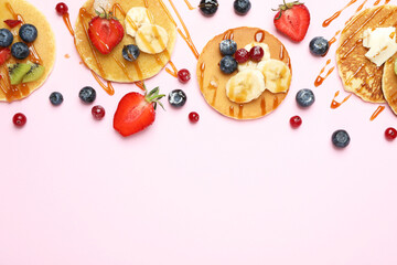 Naklejka na ściany i meble Concept of delicious dessert with pancakes on pink background