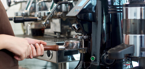 Barista making fresh espresso coffee. Espresso Machine Portafilters. Closeup