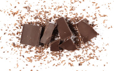 Chocolate pieces and grated flakes, shavings pile isolated on white background, top view