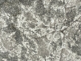 Different textures and colourations of cracked floor concrete.