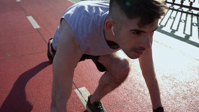 Sportsman with scars on skin using earphones before run