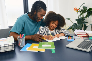 Fototapeta Father helps his daughter doing school homework at home. Father's day, happy dad and schoolgirl, happy family obraz
