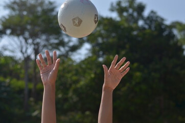 male hands playing volley ball gesture at the beach