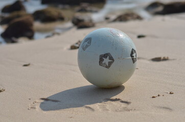 white ball in the beach sands