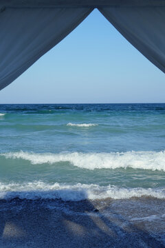 View of sea with foamy waves from baldaquin on the beach. Black Sea shore in Romania

