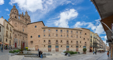 Panoramic view with Casa de las Conchas latera facade and baroque iconic facade at the La Clerecía building, Pontifical university at Salamanca