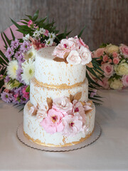 Beautiful wedding cake with flowers in several layers.