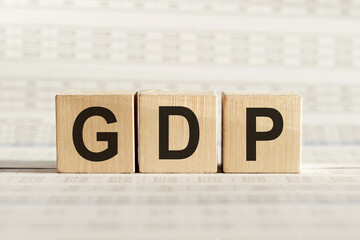 GDP abbreviation - gross domestic product, on wooden cubes on a light background.
