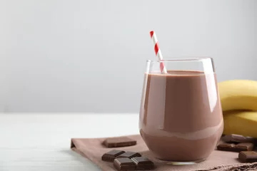 Foto op Plexiglas Fresh yummy chocolate milk on white wooden table. Space for text © New Africa