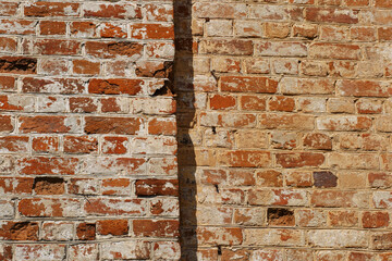A battered red brick wall