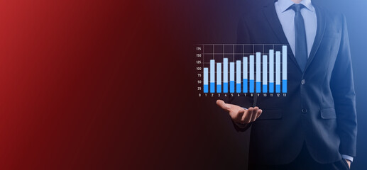 Businessman hold drawing on screen growing graph, arrow of positive growth icon.pointing at creative business chart with upward arrows.Financial, business growth concept.
