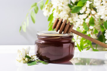 Natural honey acacia in a jar close-up.