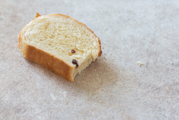A slice of bread on the kitchen table background.
