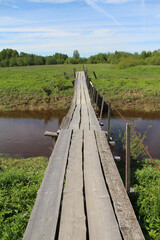 Wooden bridge on the lake and autumn trees on the shore