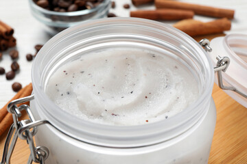 Body scrub in glass jar on table, closeup